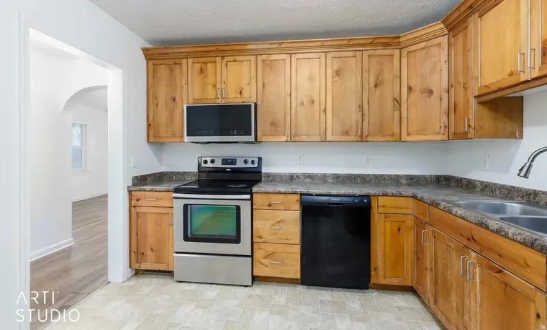 Wood-finish cabinetry paired with dark countertops