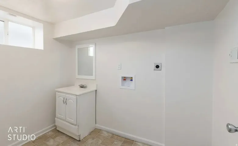 White vanity with integrated sink, wall-mounted mirror, and vinyl flooring