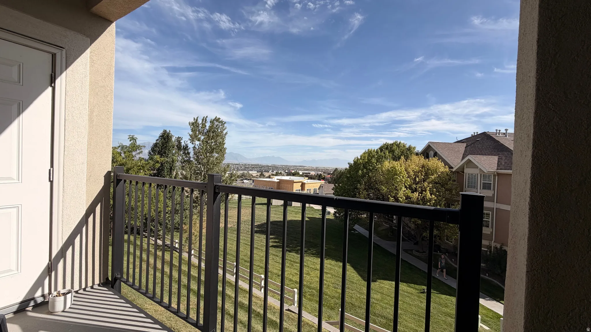 Private balcony featuring a metal railing and stucco exterior