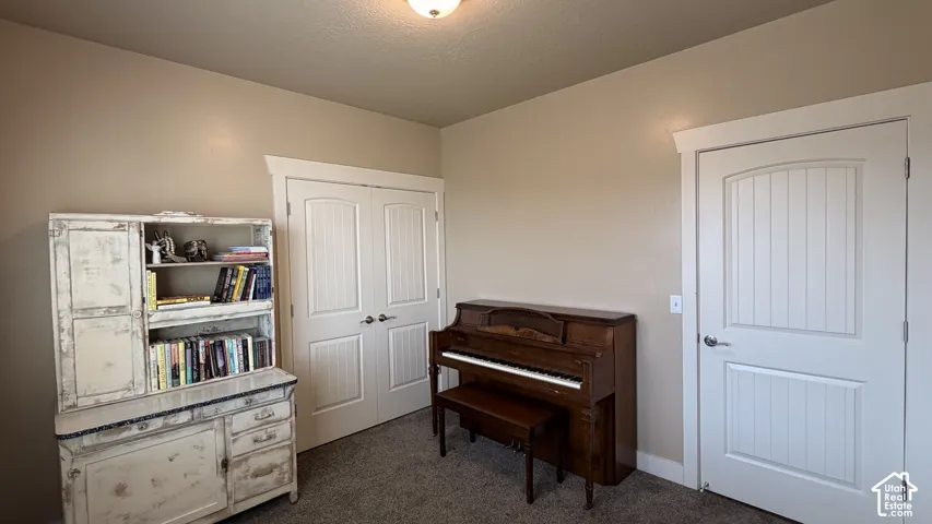 Neutral wall paint, plush carpet flooring, and white interior doors with architectural trim