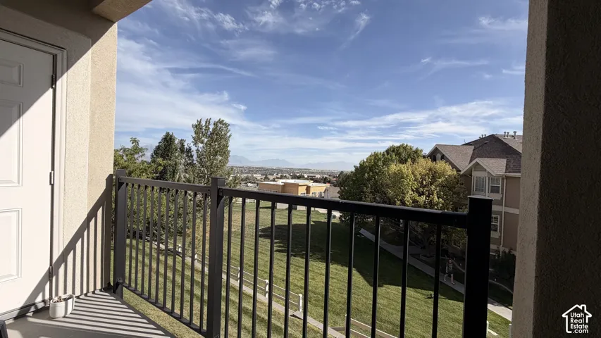 Private balcony featuring a metal railing and stucco exterior