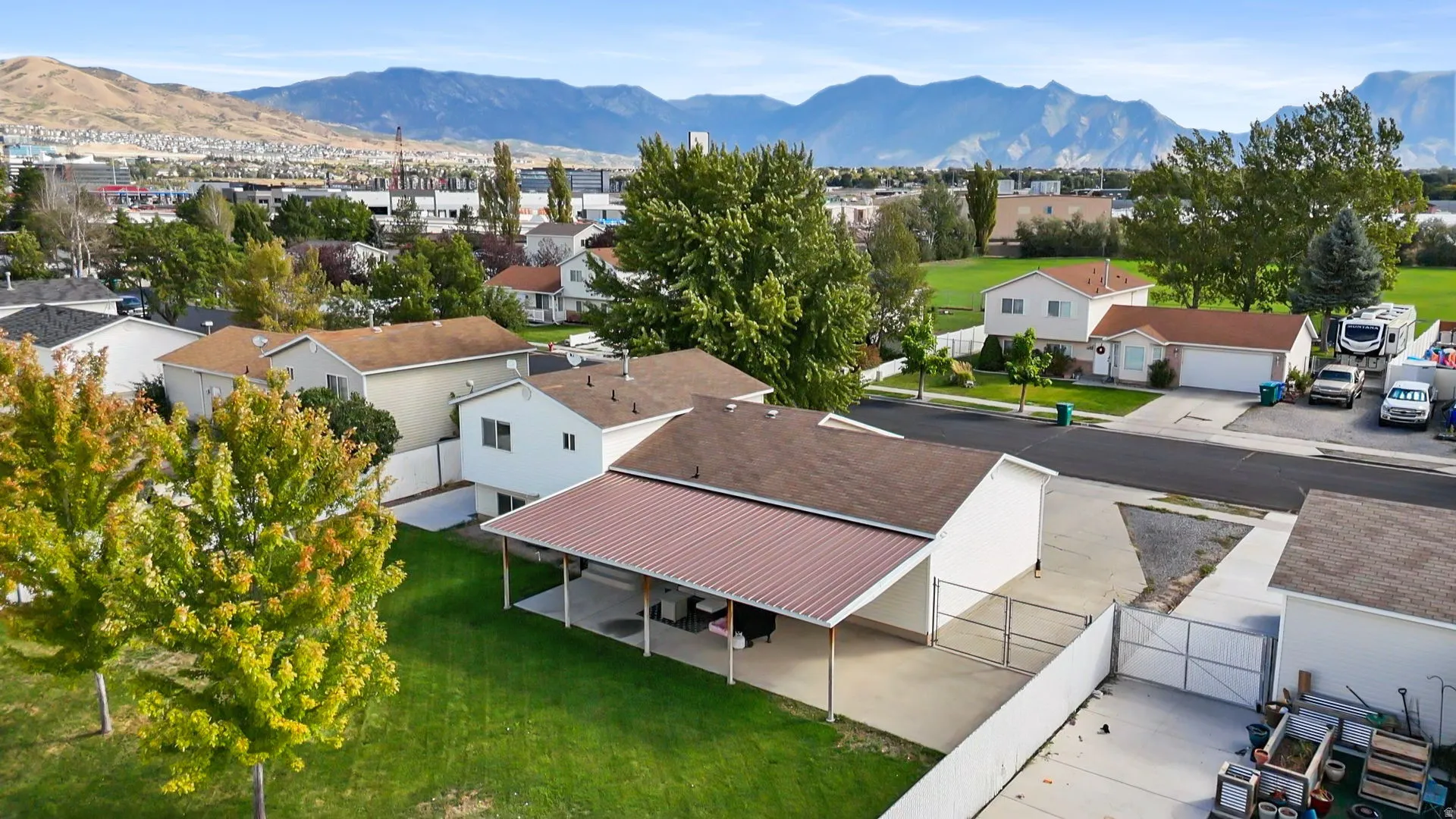Expansive yard featuring a covered patio, detached garage, and perimeter fencing
