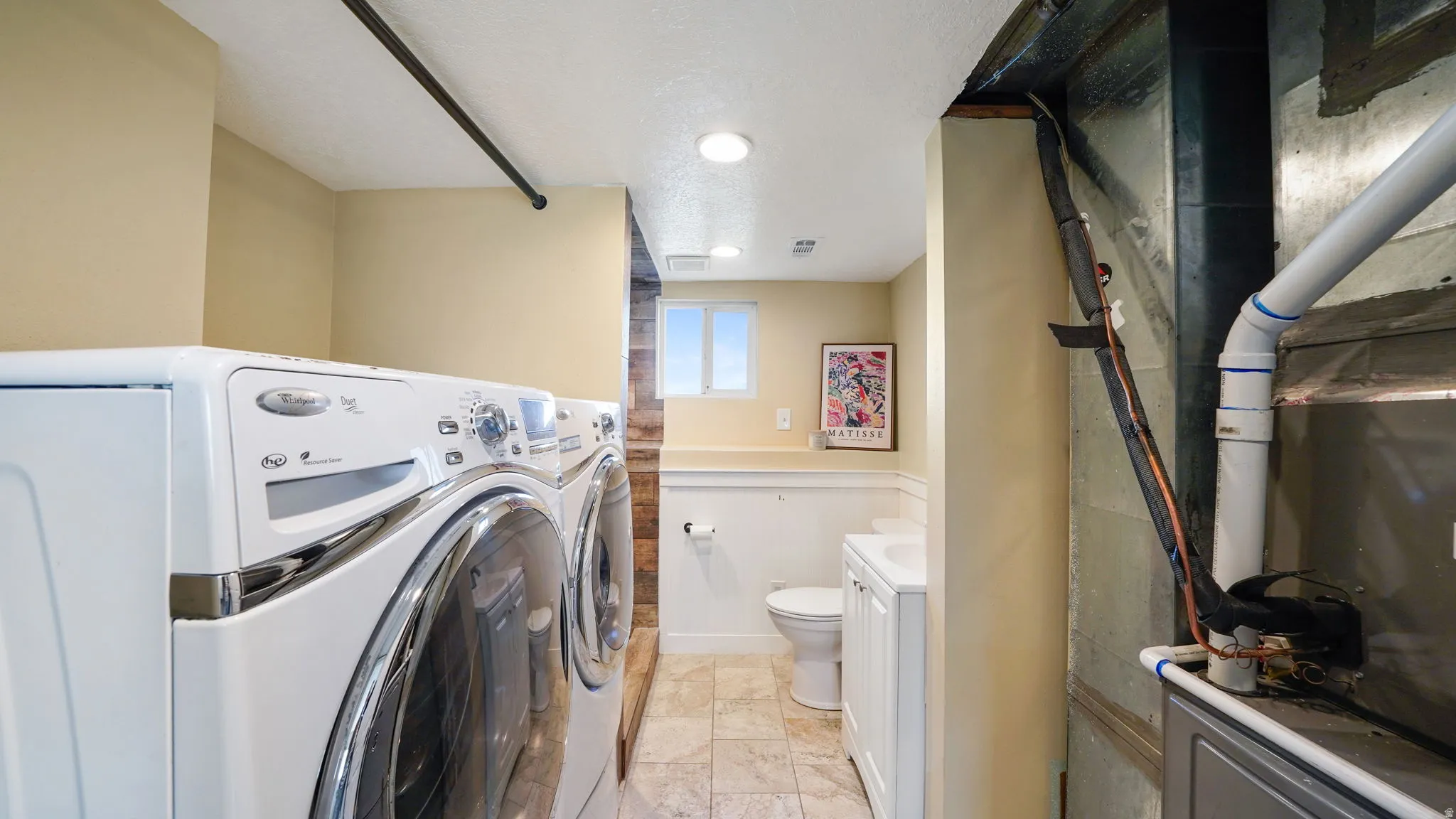 Laundry area with tile flooring and recessed lighting