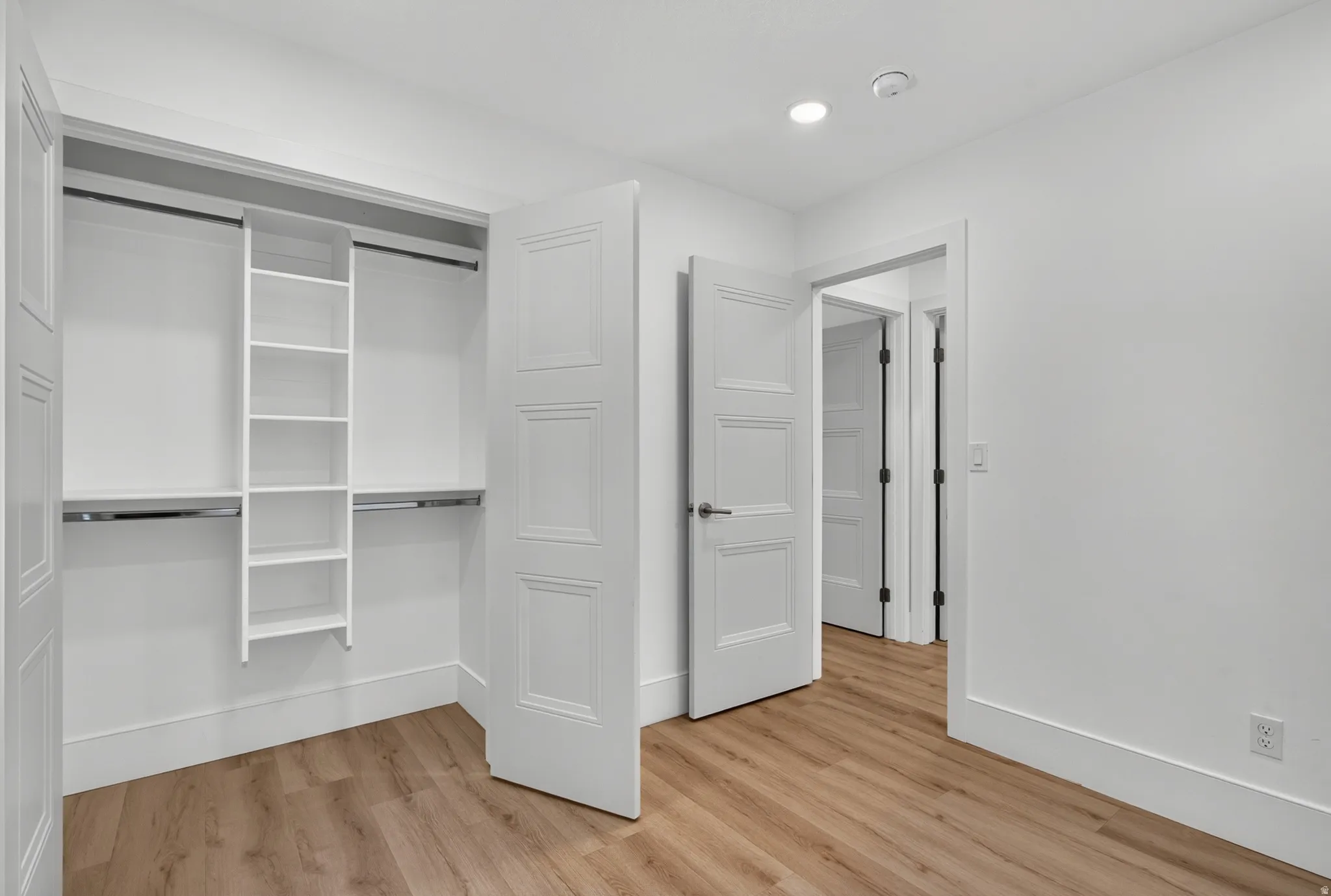 Custom closet organization system with shelving and hanging rods
