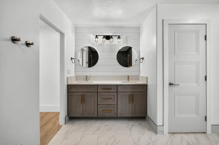 Double vanity with undermount sinks and brass hardware