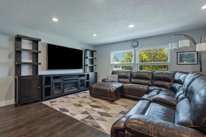 Wood-finish flooring, recessed lighting, and large windows with blinds