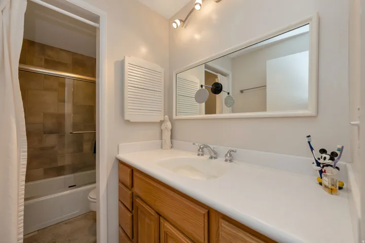 Wood-finish vanity with an integrated sink and chrome fixtures