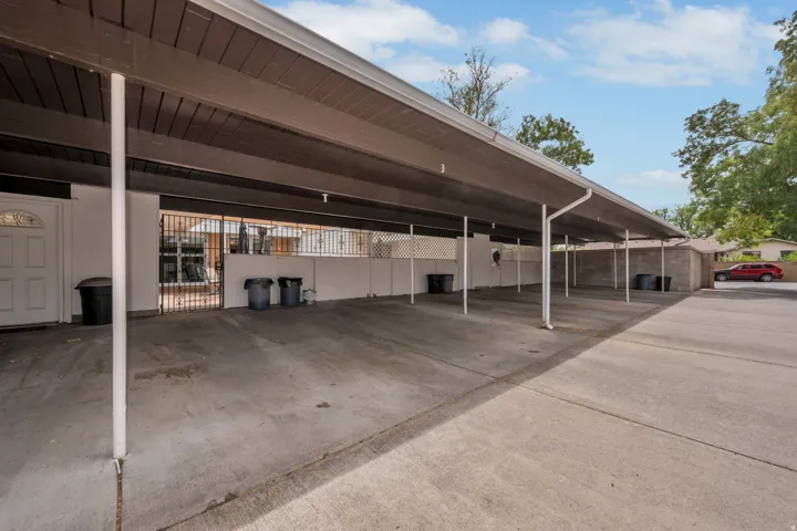 Covered carport parking with concrete flooring and direct access to the entrance