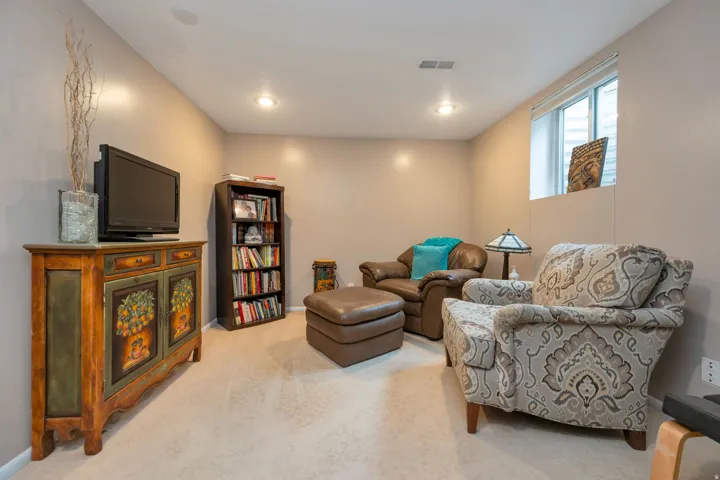 Recessed lighting, wall-to-wall carpeting, and a window with blinds