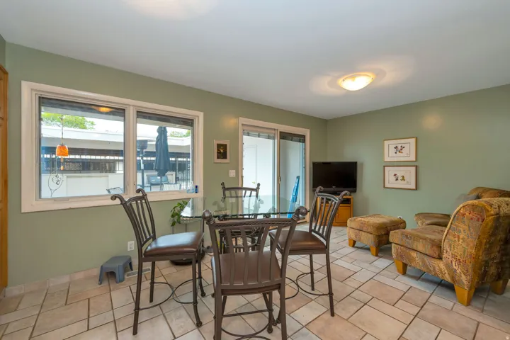 Tile flooring throughout, recessed lighting, and a sliding glass door