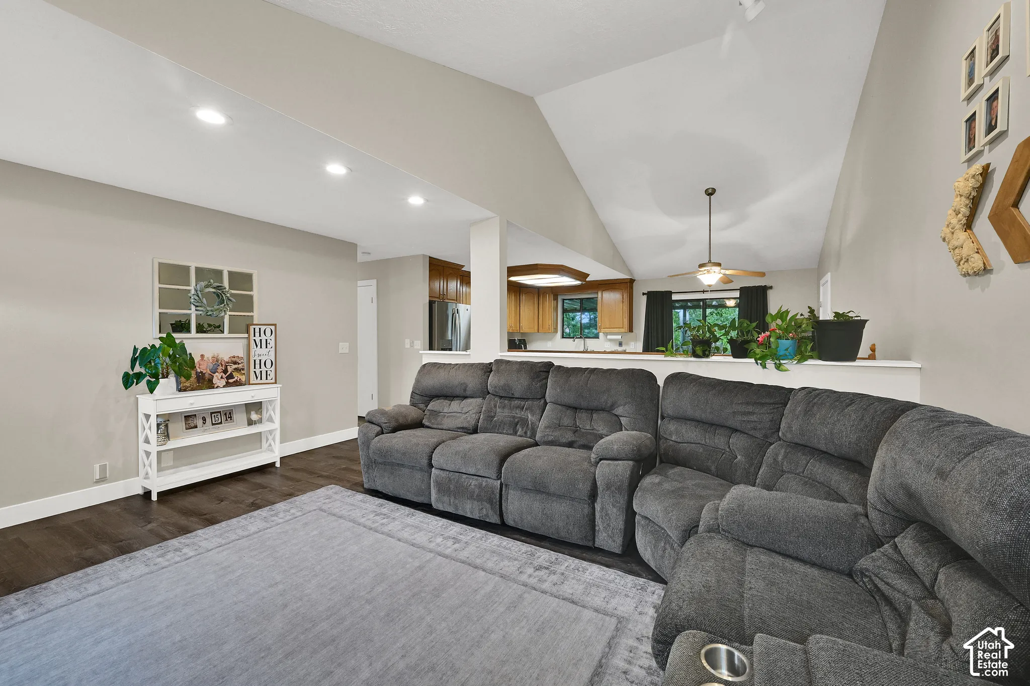 Vaulted ceiling, recessed lighting, wood-finish flooring, kitchen pass-through, and ceiling fan