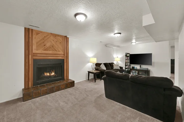 Fireplace featuring a wood surround with a herringbone pattern