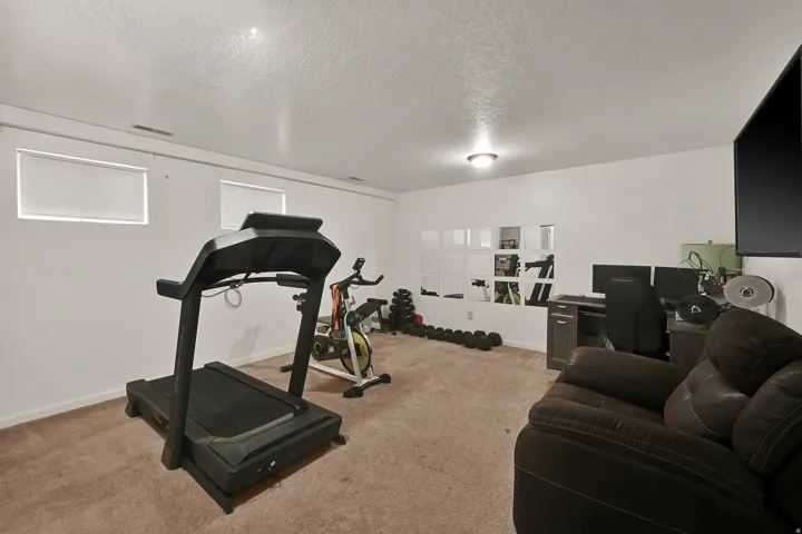 Carpeted room with recessed windows and wall-mounted lighting