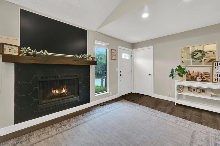 Fireplace featuring a rich wood mantle and hexagonal tile surround