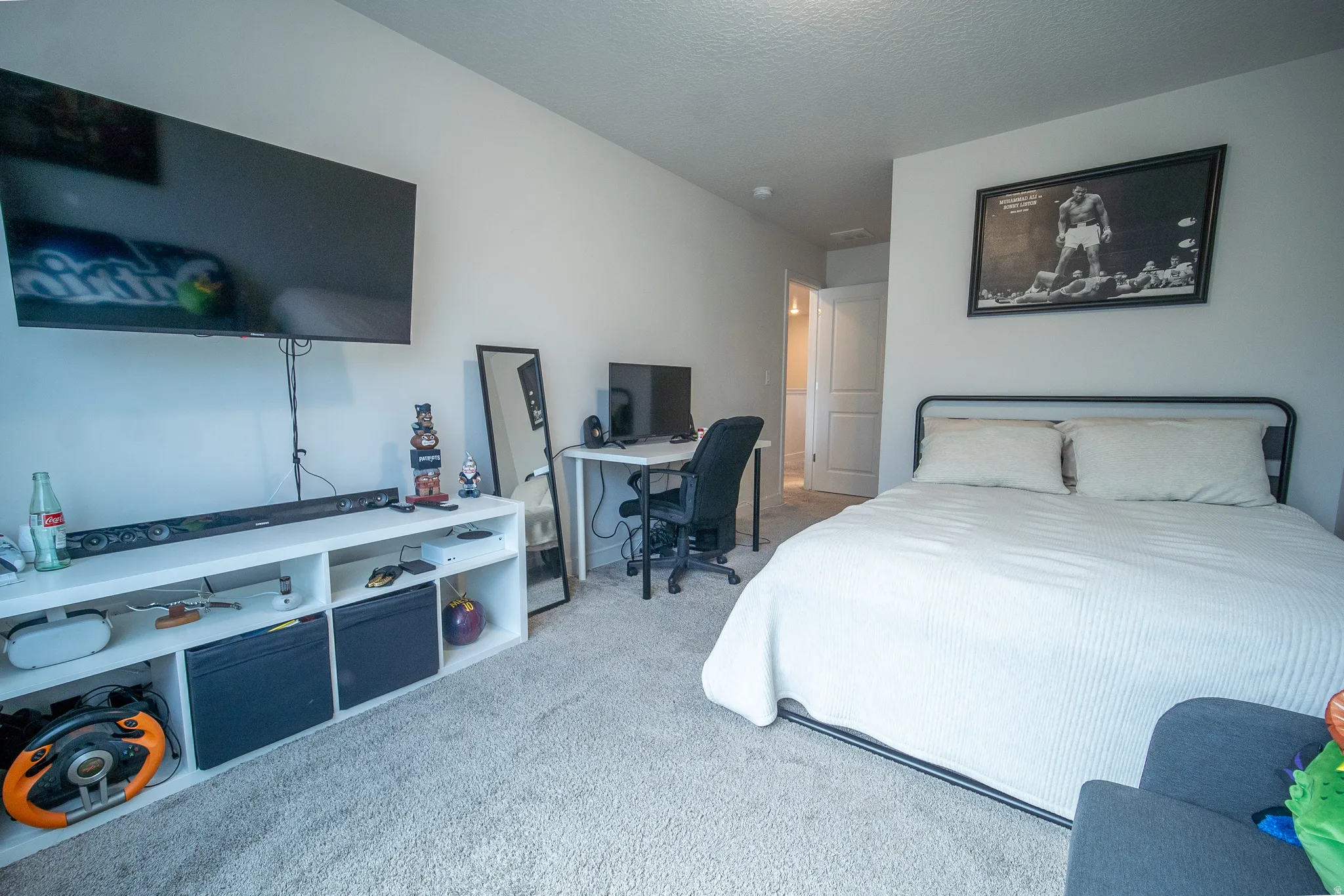 Bright and spacious bedroom with large windows, soft carpeting, and a versatile floor plan that easily accommodates a variety of furniture arrangements.