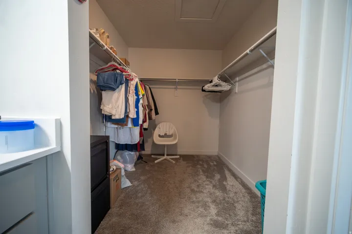 Spacious walk-in closet featuring built-in shelving and hanging space designed to provide excellent organization and storage.