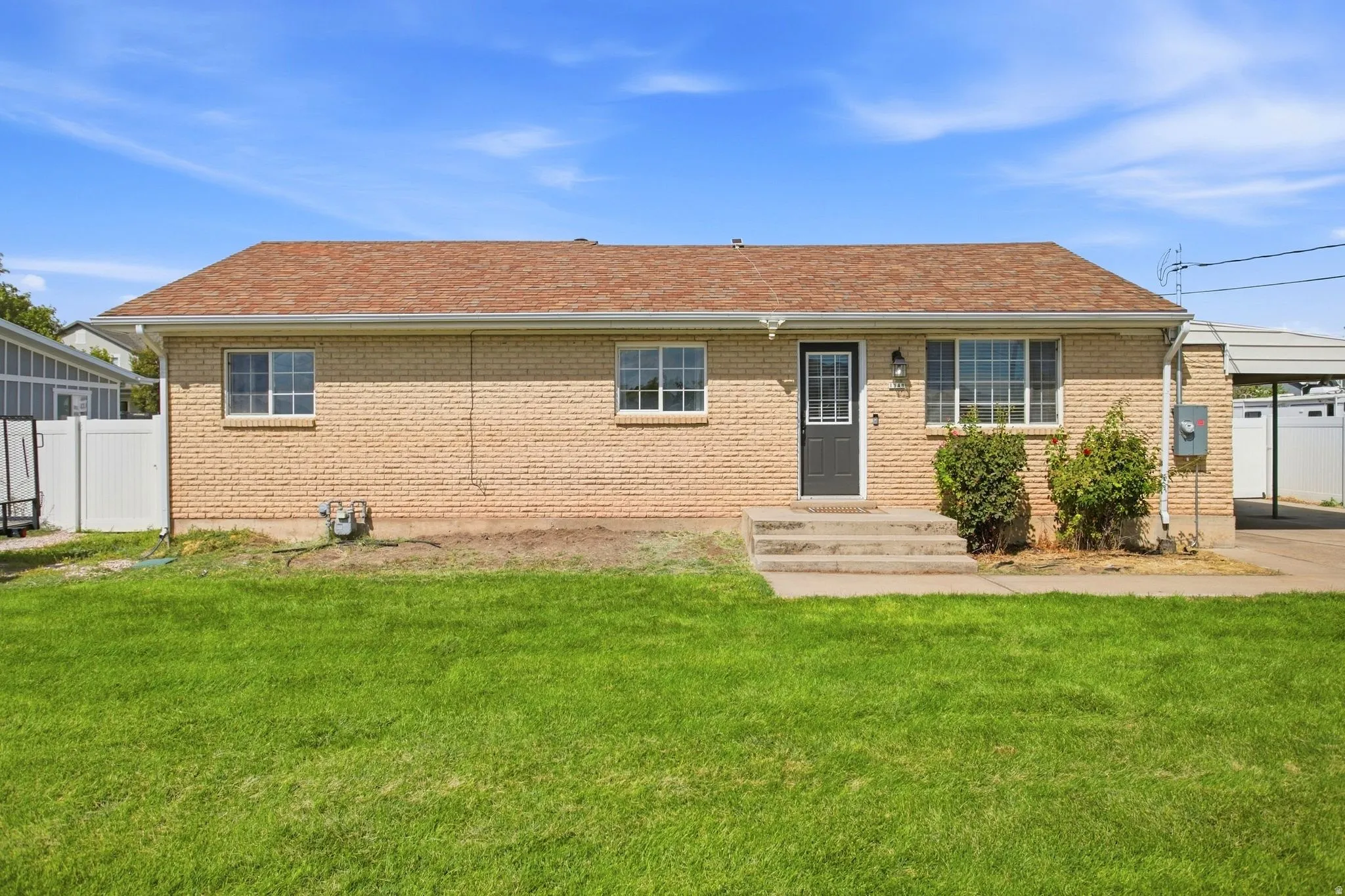 Brick exterior with a brown shingle roof