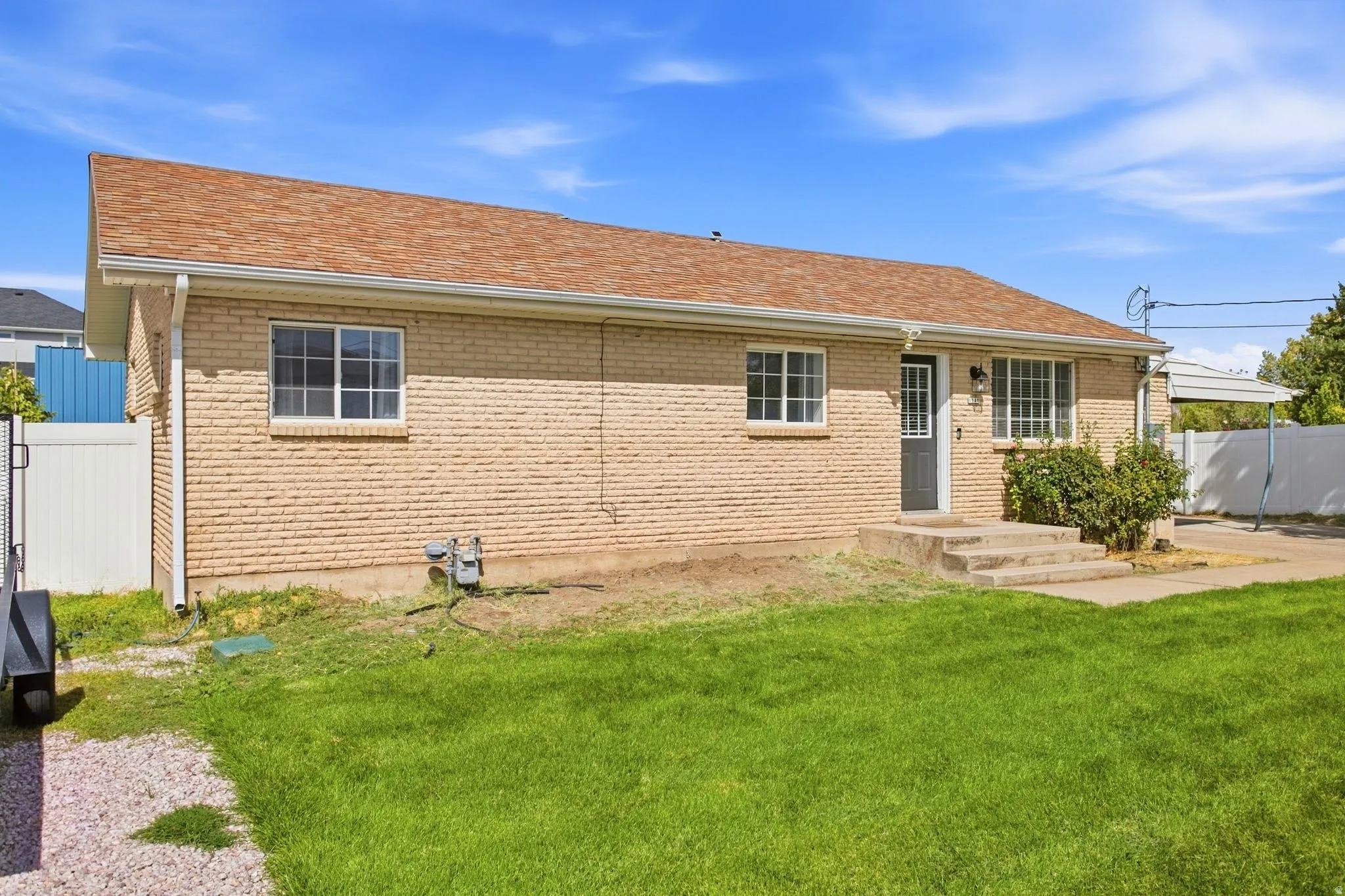 Brick exterior with a brown shingle roof
