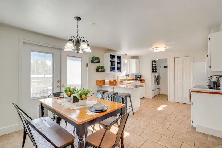 Tile flooring, white cabinetry, a built-in kitchen island, and a built-in shelving unit