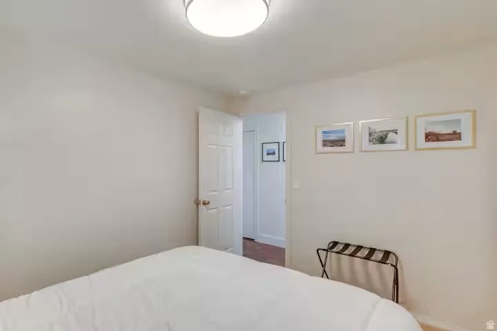 Recessed ceiling light fixture, neutral wall paint, and white paneled interior door