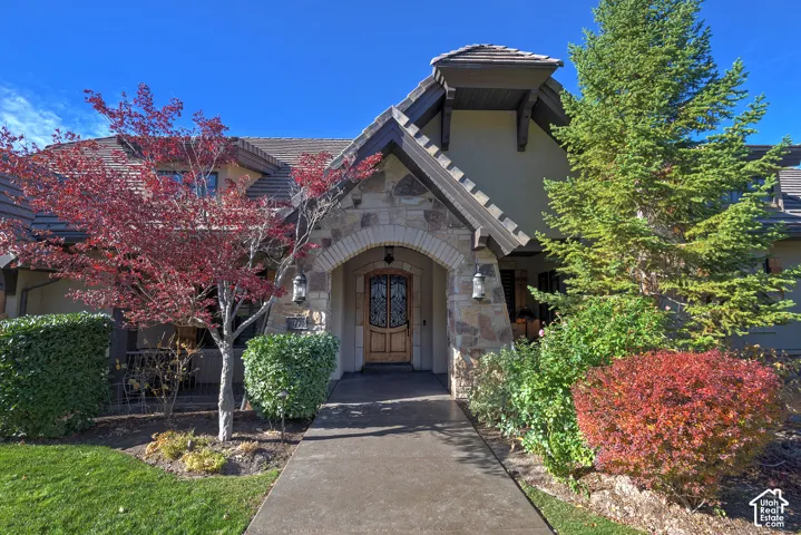 Stone and stucco exterior with a prominent arched entry