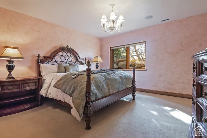 Textured wall finish, recessed lighting, chandelier, wood trim, window with natural scenery