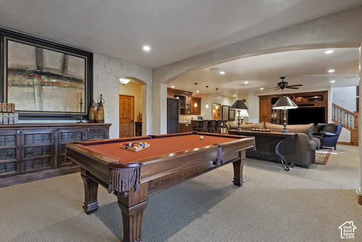 Archway entry, recessed lighting, built-in entertainment center, wood-finish cabinetry, ceiling fan