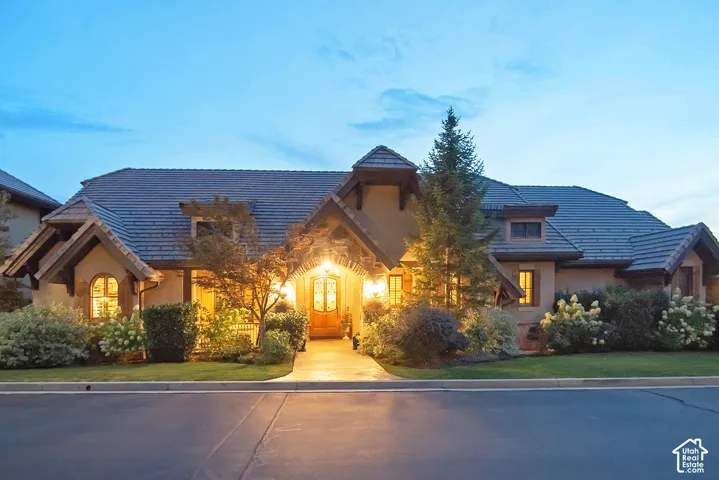Stone and stucco exterior with a multi-level tile roof