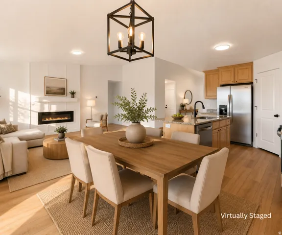 Wood-finish flooring throughout, kitchen island with granite countertop, stainless steel appliances, built-in electric fireplace, and a decorative lantern light fixture