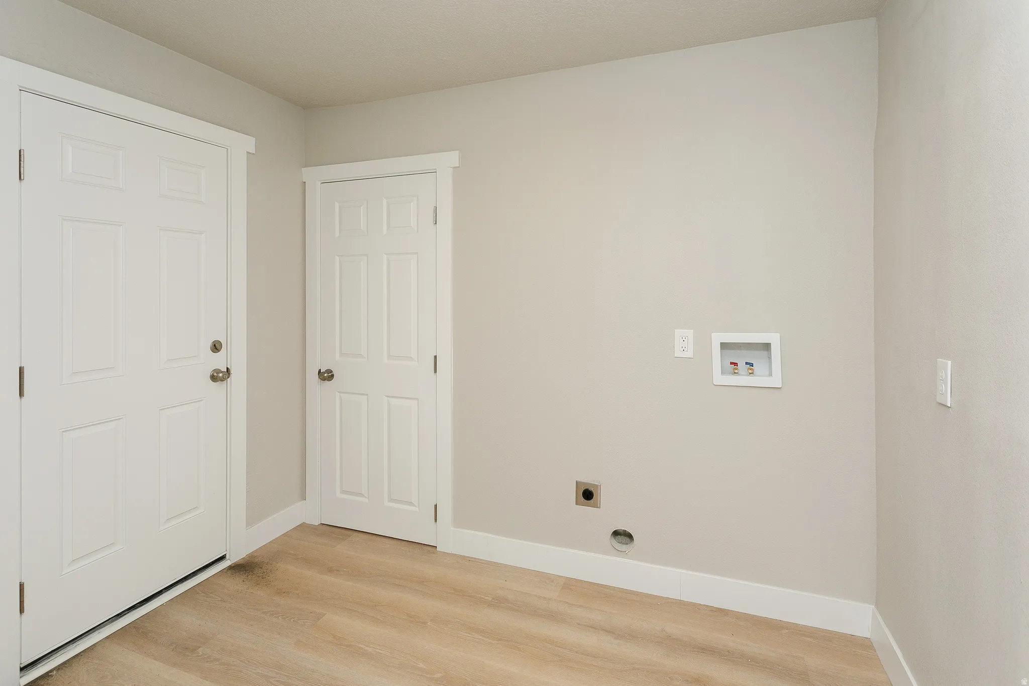 Light wood-finish flooring with crisp white trim