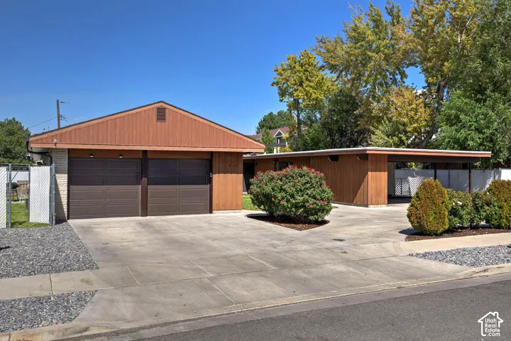 Two-car garage with brown panel doors and a wood-paneled gable