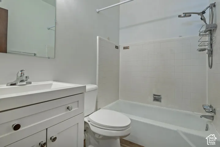 White vanity with chrome hardware, integrated sink, and chrome faucet