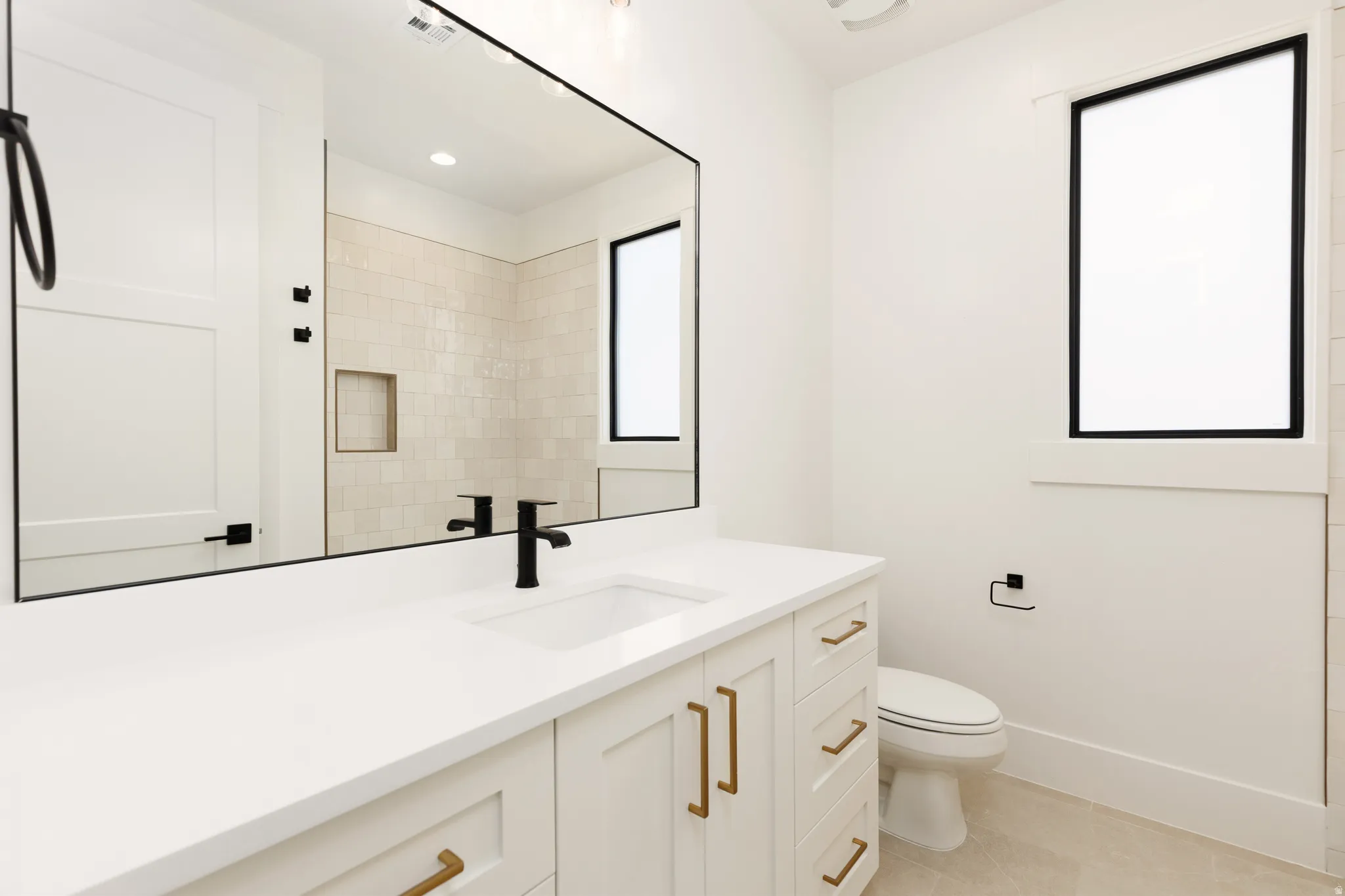 Vanity with integrated sink and matte black faucet