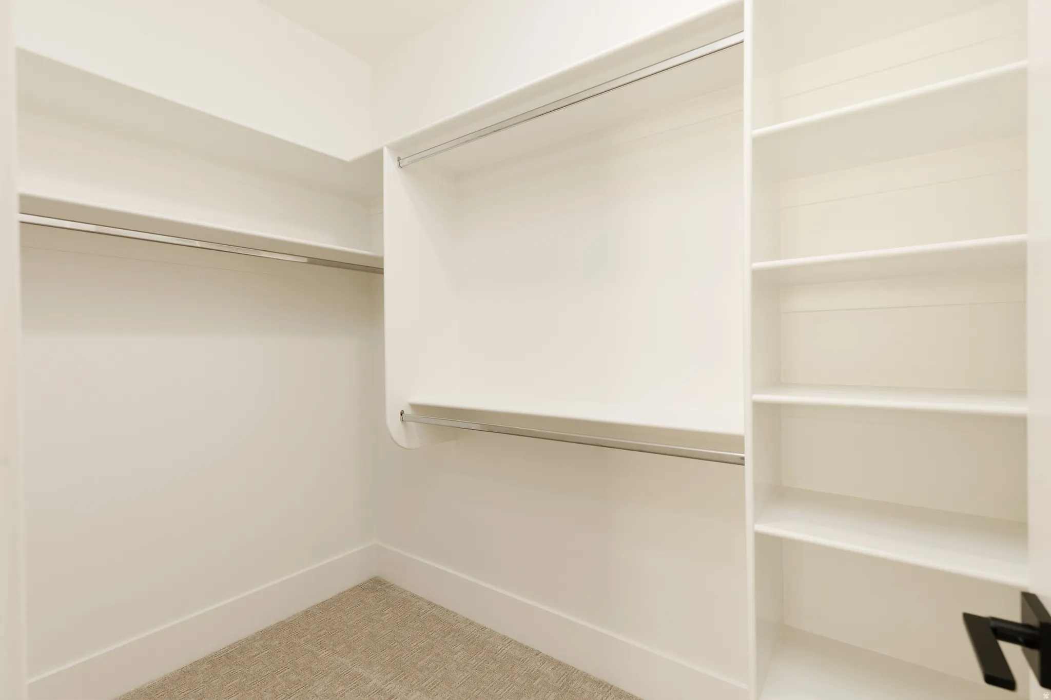 Built-in closet system featuring multiple hanging rods and integrated shelving