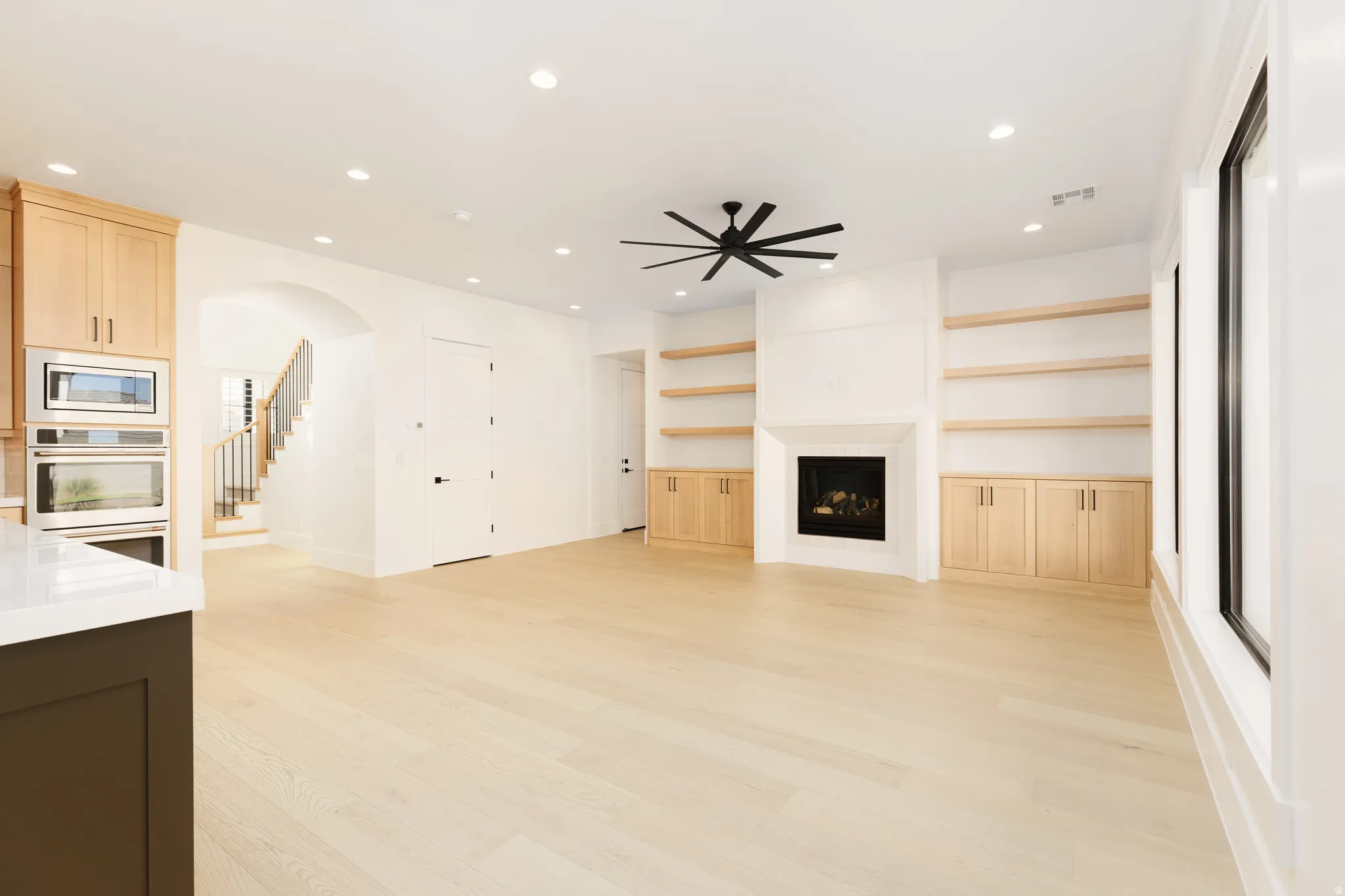 Light wood-finish flooring with recessed lighting