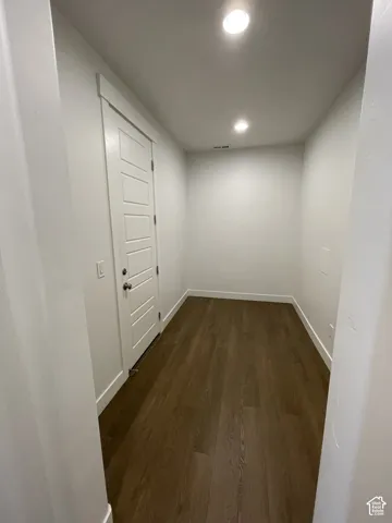 Recessed lighting illuminates wood-finish flooring