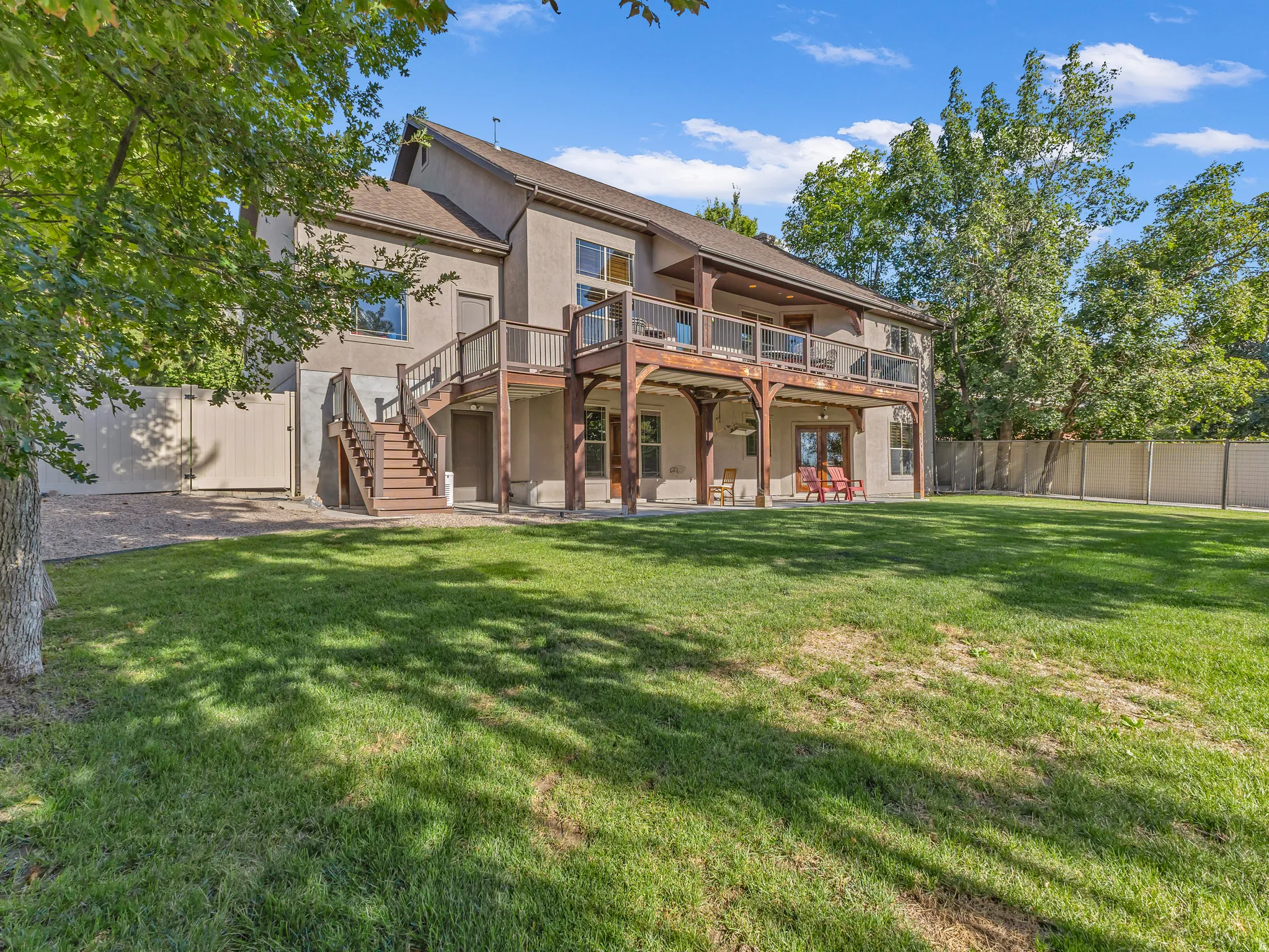 Deck spans the length of the home with stairs leading to the yard