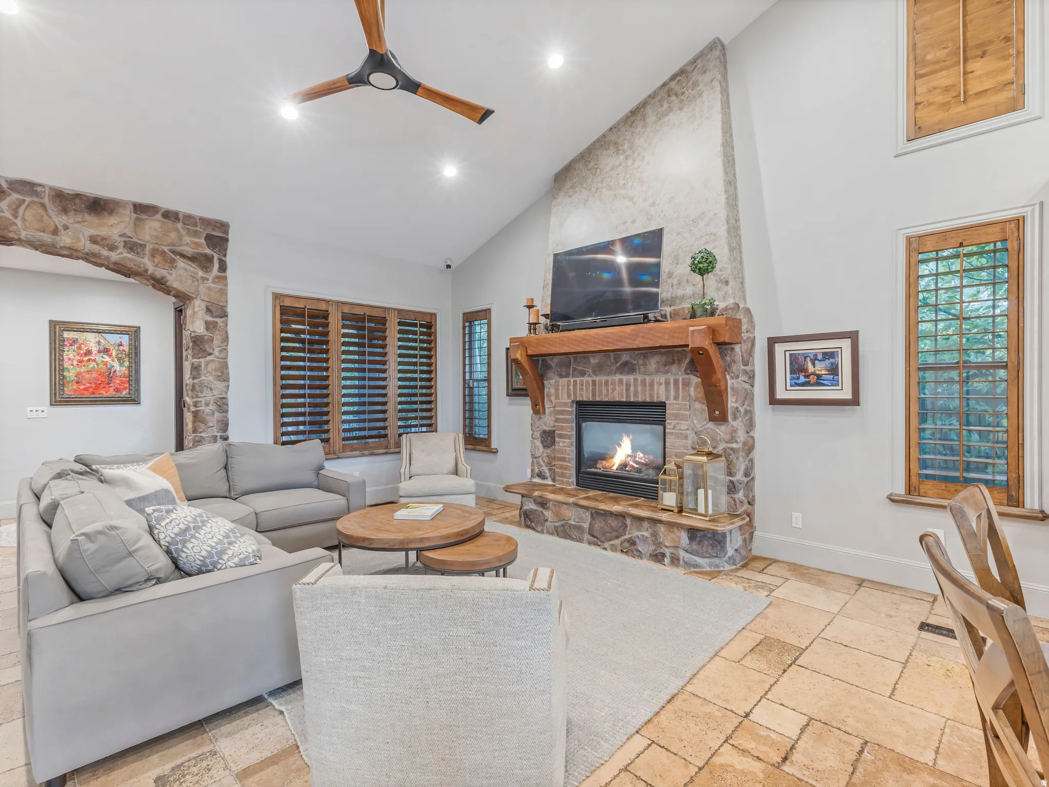 Warm and inviting with stone fireplace.  Wood plantation shutters throughout