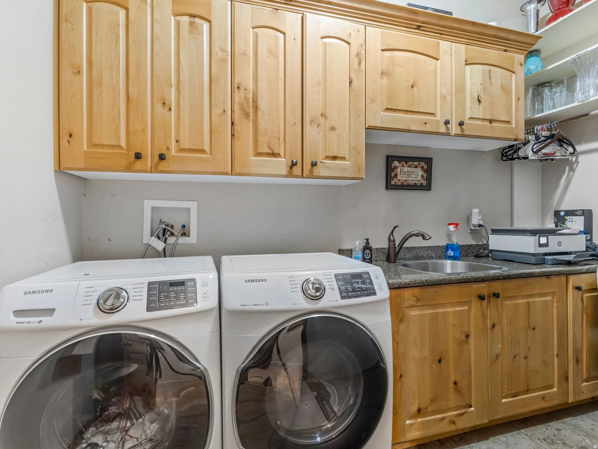 Main floor laundry with sink and tons of cabinets