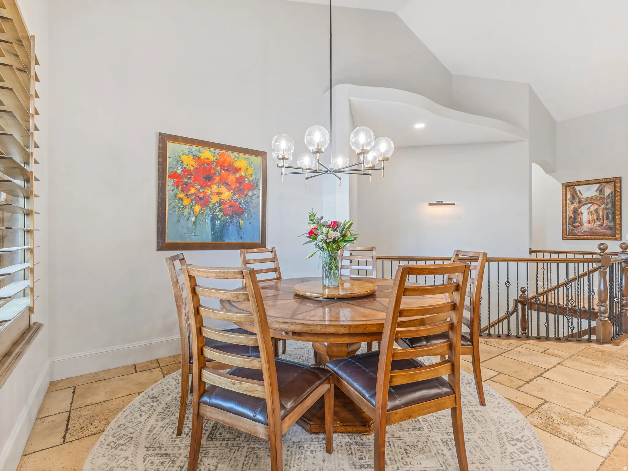 Spacious dining area featuring a contemporary chandelier,.