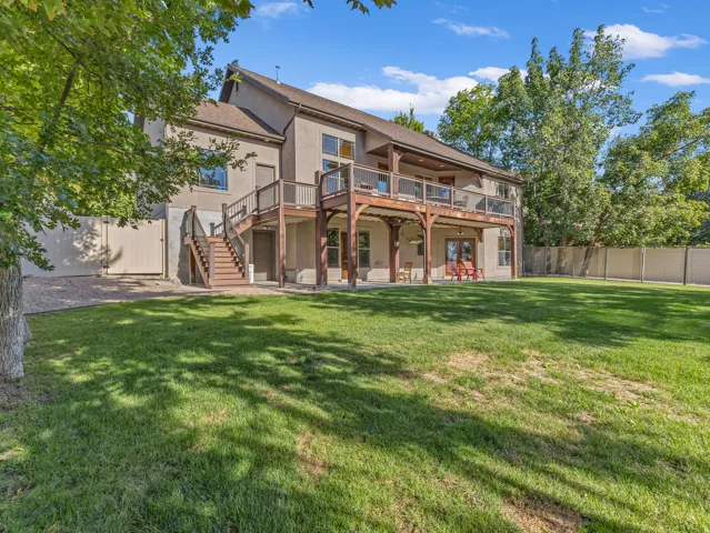 Deck spans the length of the home with stairs leading to the yard
