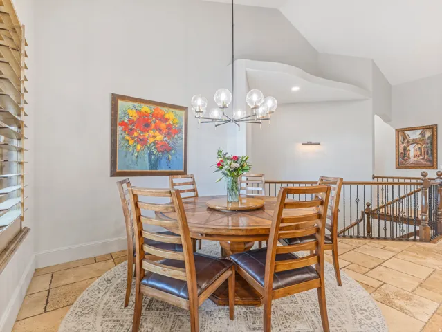Spacious dining area featuring a contemporary chandelier,.