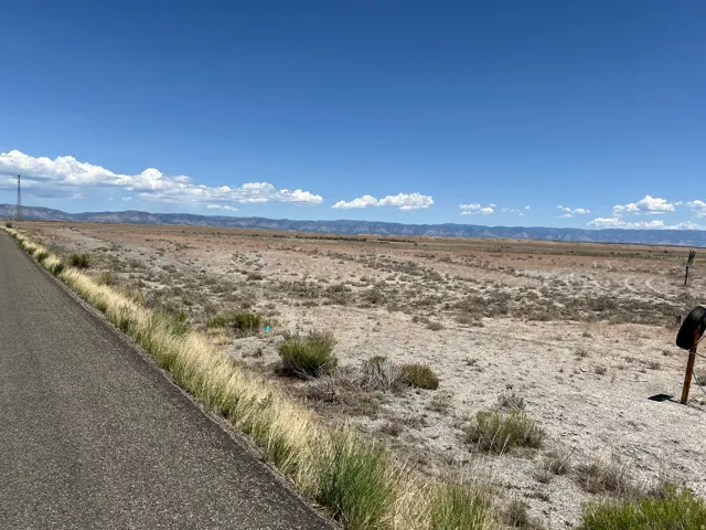 Expansive open lot with distant mountains under a clear sky