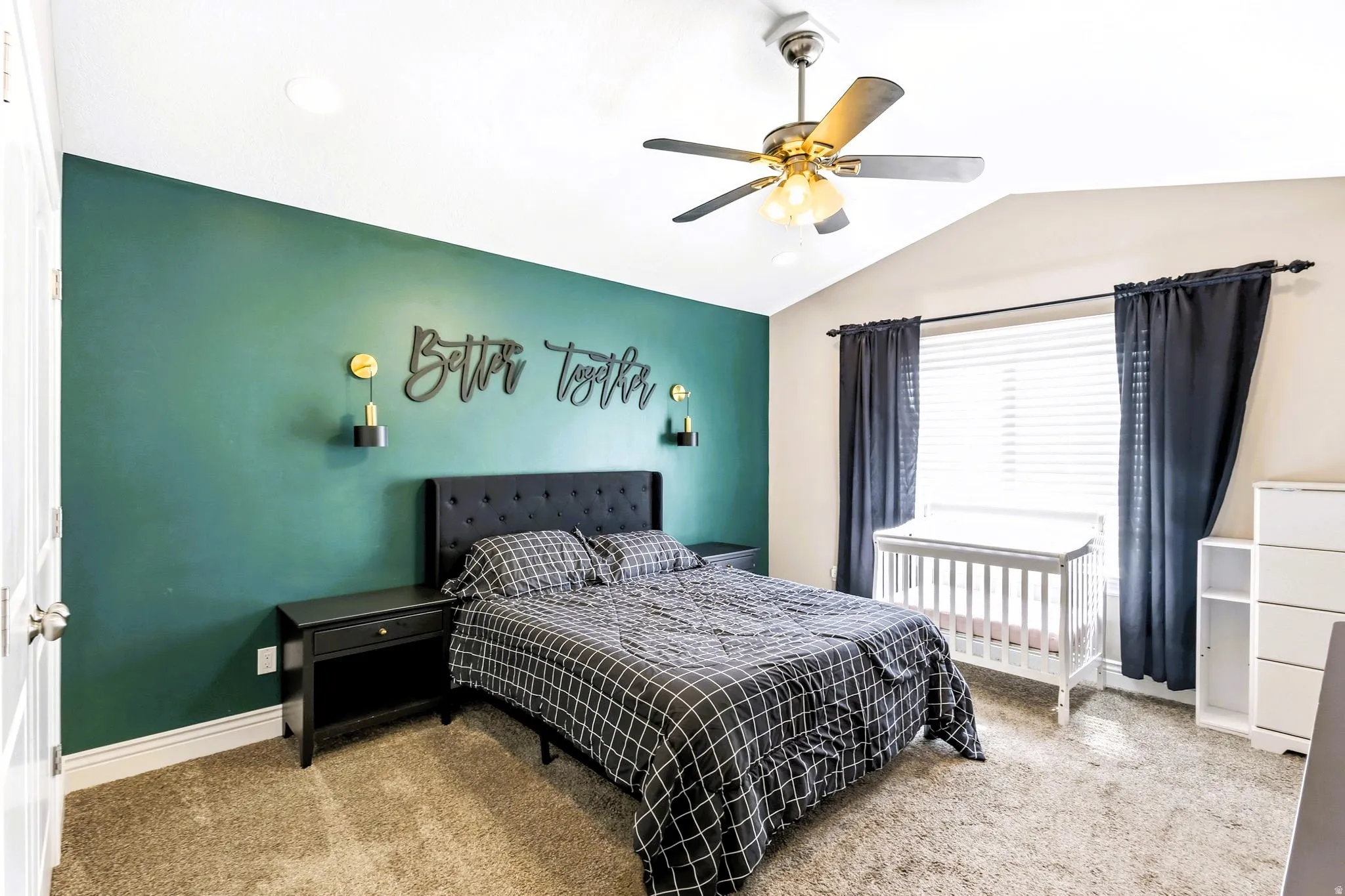 Primary bedroom with vaulted ceiling and ceiling fan light fixture, recessed lighting, carpet flooring, and window blinds.