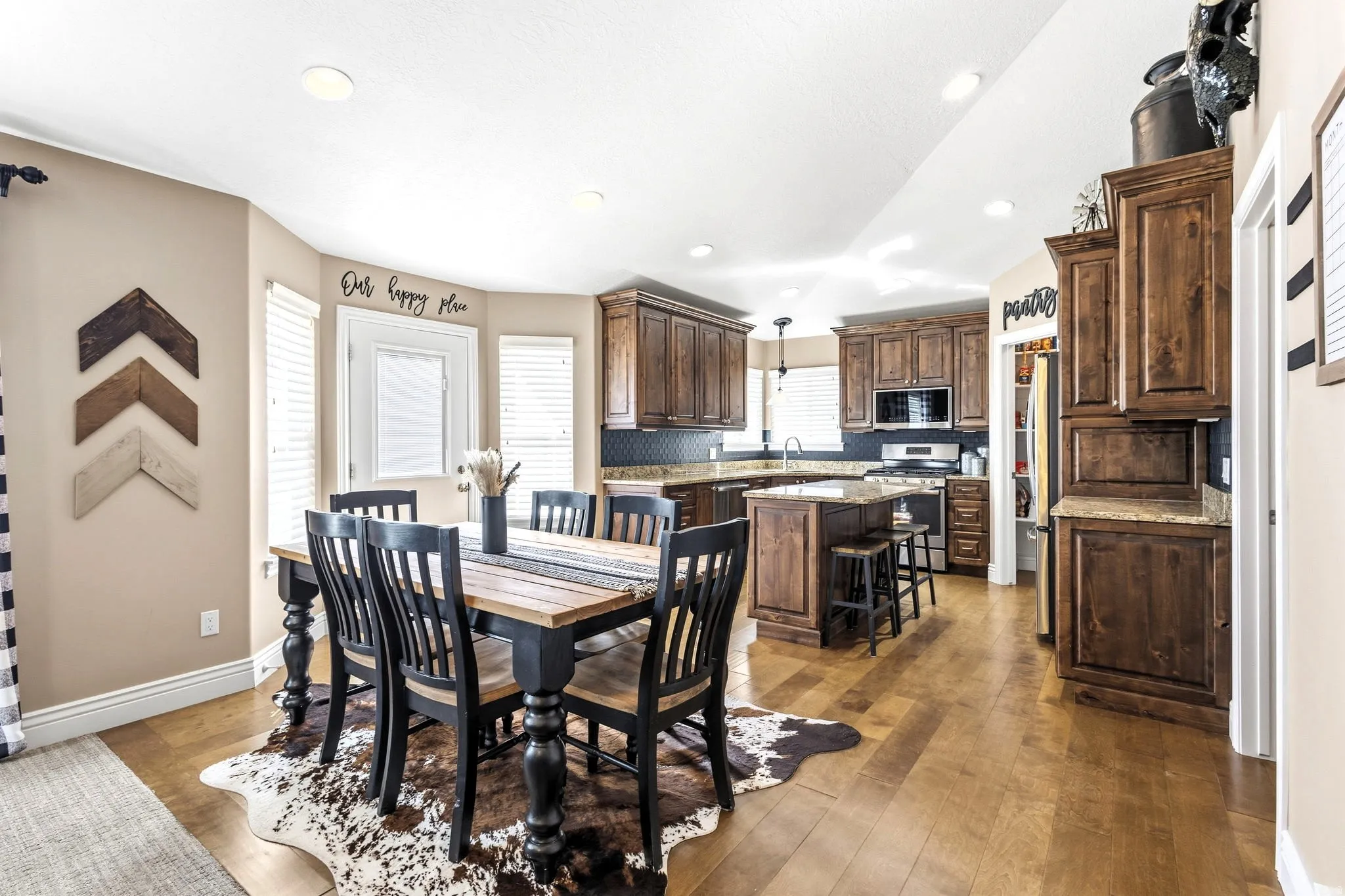 Hardwood-finish flooring extending through dining and kitchen areas
