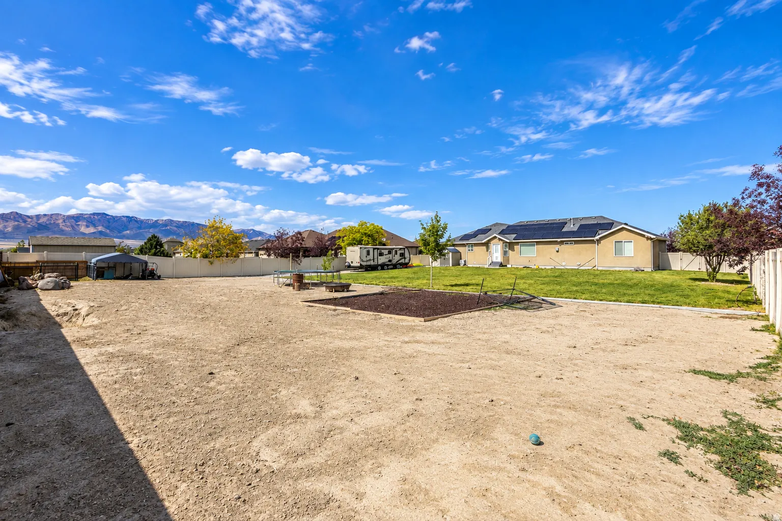 Expansive backyard with plenty of RV parking and a perimeter fence