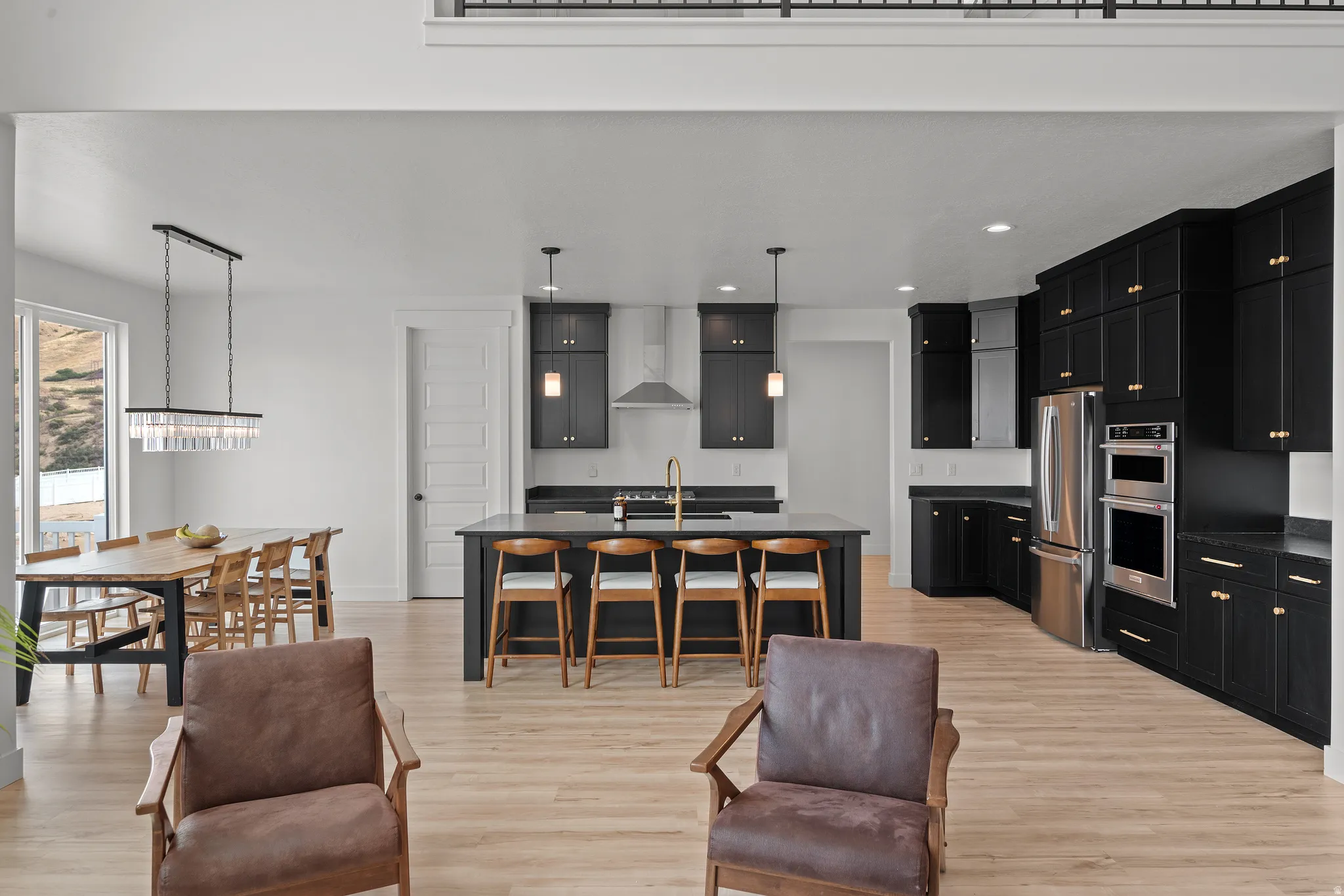 Open-concept living space with light wood-finish flooring