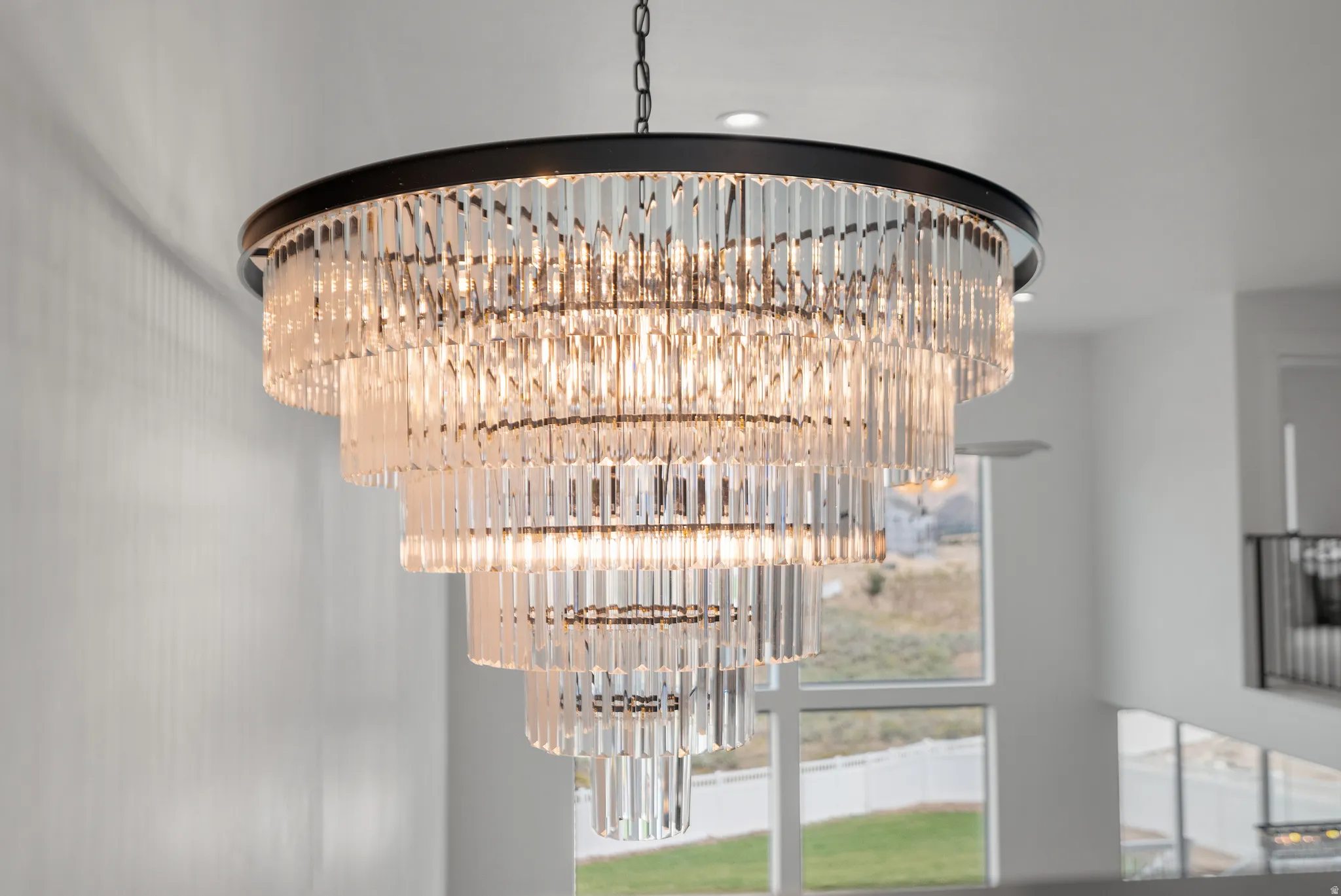 Tiered crystal chandelier with a matte black frame