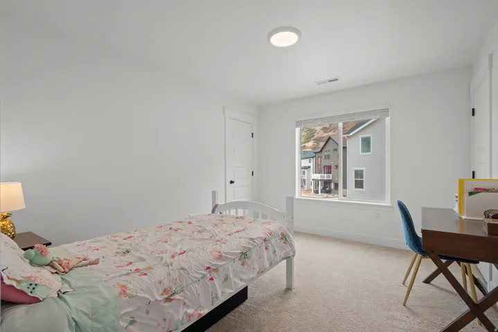 Neutral wall paint, window with blinds, baseboard trim, carpet flooring, and a flush mount ceiling light