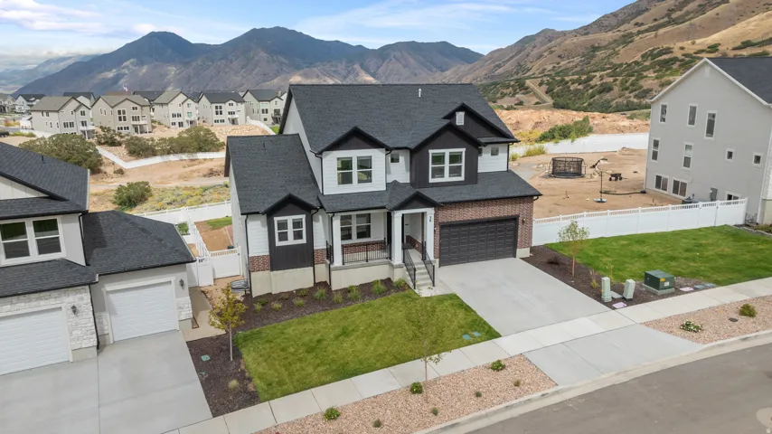 Modern two-story residence with a dark shingle roof and a two-car garage